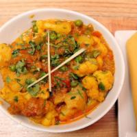 Aloo Gobi Mutter · Potatoes and cauliflower cooked with green peas and Indian spices.