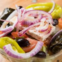 Greek Salad · Mixed greens, tomatoes, cucumbers, red peppers, grape leaves, feta cheese, olives, red onions.
