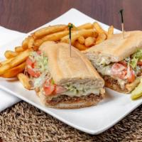 Steak And Cheese Sub · 100% rib eye steak and melted cheese, grilled onions, lettuce, tomatoes, mayo, pickles, and ...