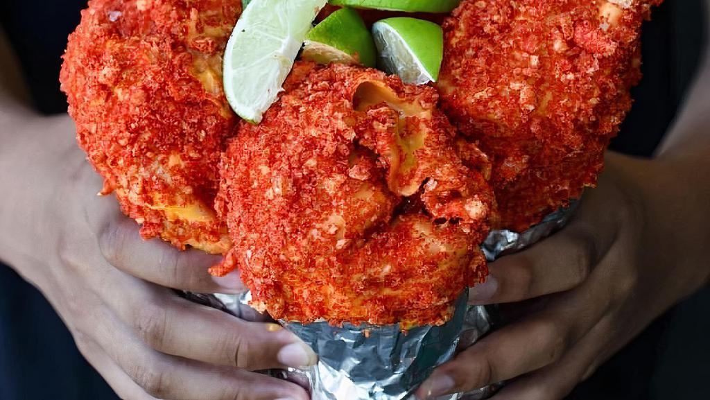 Hot Cheetos Burrito · 13 INCH FLOUR LAYERED WITH: SHREDDED CHEESE, (CHOICE OF PROTEIN), GUACAMOLE, ONION, CILANTRO, TOMATO SLICES, CREMA, HOT CHEETOS AND NACHO CHEESE.