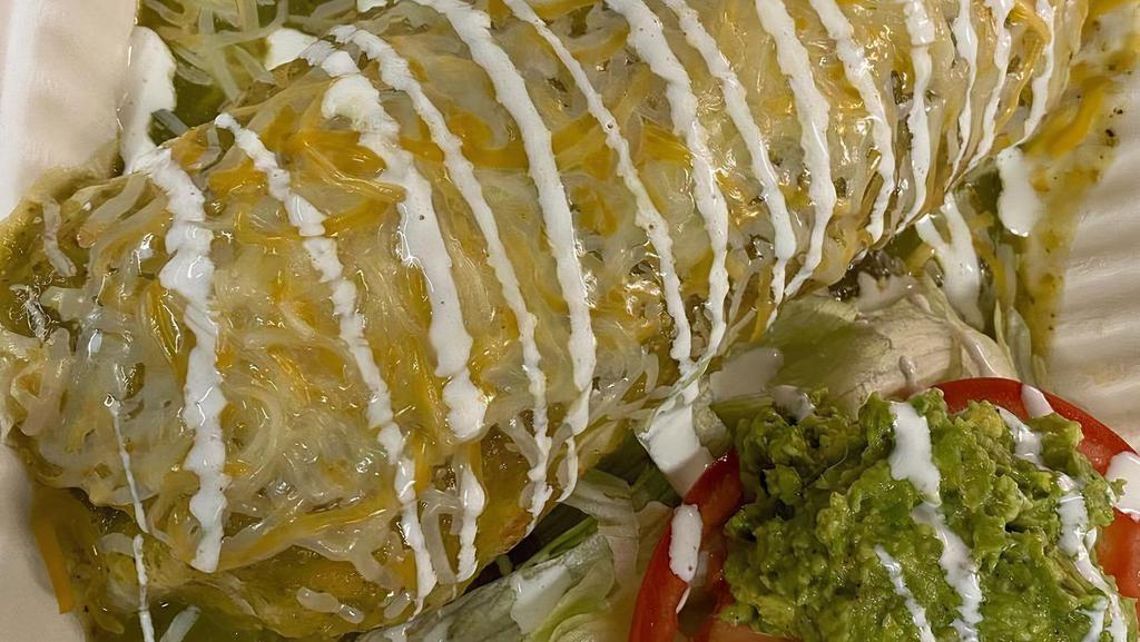 Wet Burrito · LOADED WITH: (CHOICE OF PROTEIN), RICE, WHOLE BEANS, ONION, CILANTRO, AND CHEESE. SMOTHERED IN OUR HOMEMADE CHILE VERDE SAUCE, CHEESE, AND CREMA, WITH A SIDE OF LETTUCE, TOMATO, AND GUACAMOLE.