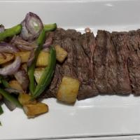 Carne Asada · Tender grilled skirt steak served with potato, jalapeño rajas, onions, guacamole and black b...