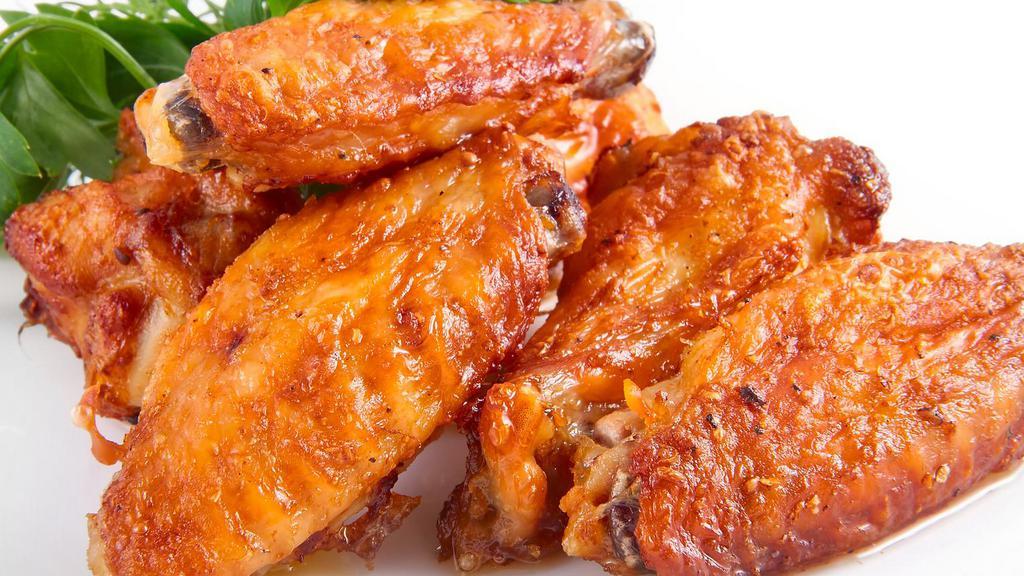 Hot Wings · 8 juicy deep-fried chicken wings tossed in our hot sauce. Comes with a bleu cheese sauce and a side of celery and carrots.