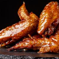 Bbq Wings · 8 juicy deep-fried chicken wings tossed in our tangy BBQ sauce. Comes with a bleu cheese sau...
