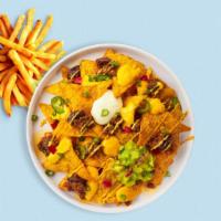Loaded Nachos · Warm nachos topped with salsa, guacamole, sour cream, and cheese.