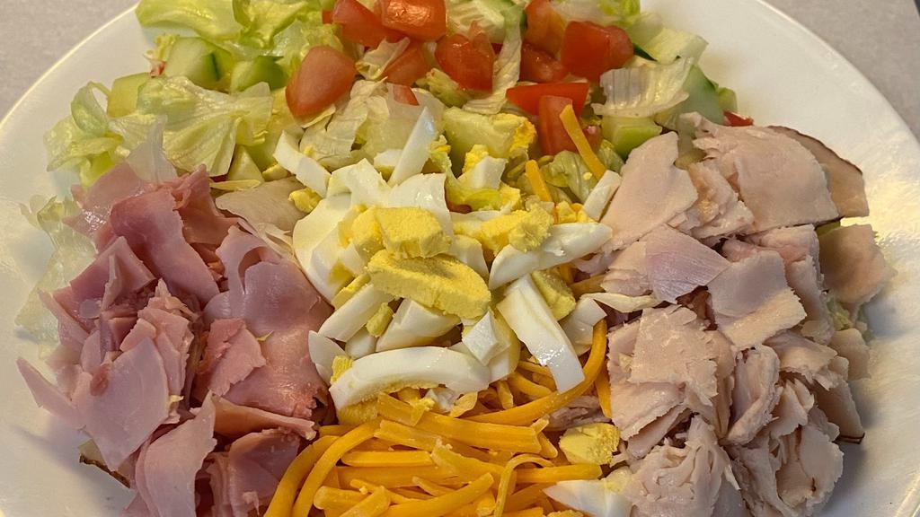 Chef Salad · Iceberg lettuce, cubed turkey, ham, Cheddar cheese, sliced hard boiled egg, cucumber and tomato with dressing of your choice.