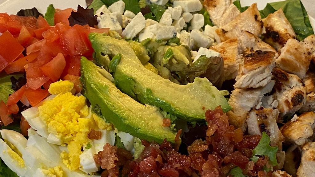 Cobb Salad · Mixed greens, grilled chicken, bacon, sliced hard boiled egg, avocado, blue cheese crumbles, tomato, with red wine vinaigrette dressing.
