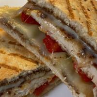 Sicilian Panini · Chicken cutlet, provolone cheese, roasted peppers, with balsamic glaze on rosemary bread.