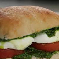 Caprese Classic Sandwiches · Fresh mozzarella, tomato, pesto, olive oil, and greens on toasted ciabatta bread.