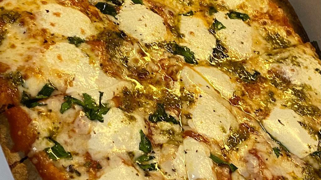 Margarita Pizza · Individual thin crust whole wheat, fresh mozzarella and basil topped pizza.