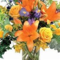 Sun-Kissed Country · This bountiful basket is overflowing with yellow lilies, tan roses, burgundy stock, coral ge...