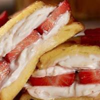 Stuffed Strawberry Cream Cheese French Toast · 3 slices of French Toast with strawberry cream cheese and topped with fresh strawberries