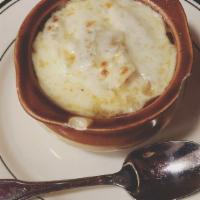 French Onion Soup Au Gratin · Spanish onions in a rich beef broth with croutons and melted mozzarella cheese.