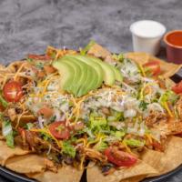 Nachos Supremos · Crispy tortilla chips with protein of your choice, served with lettuce, onion, tomato, sheer...