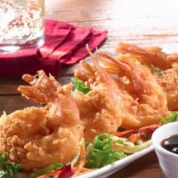 Orange Ginger Tempura Shrimp · Four jumbo shrimp tempura battered to order and served on a bed of warm garlic slaw with an ...