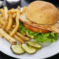 Grilled Chicken Sandwich · A grilled, marinated chicken breast on a toasted bun with lettuce and tomato. Served with ho...