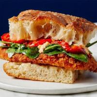 Chicken Milanese Sandwich · Crispy breaded chicken breast, melted mozzarella, peppers, and spinach tossed in our house-m...