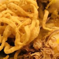 Khao Soi · Chiang Mai's most popular creamy yellow curry broth noodle with pickled mustard, fried shall...