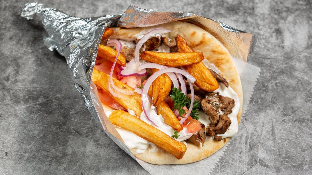 Grk Shawarma · Fresh lamb shawarma, never frozen or processed in a flat Greek pita with tomatoes, onions, fries and tzatziki.