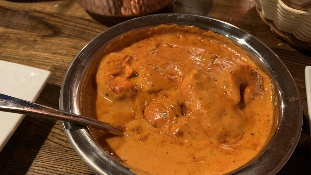 Chicken Tikka Masala · Marinated cubes of chicken grilled in a tandoor oven and simmered in a mild creamy tomato sauce.