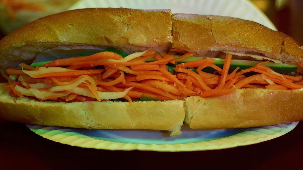 Classic Sandwich · Pate, Vietnamese ham, roasted ground pork with mayo, butter, cucumber, julienne carrots and daikon radish, and cilantro, served on a toasted French baguette.