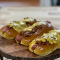 The Dc Dog · Grilled with chili and cheese on a brioche bun.