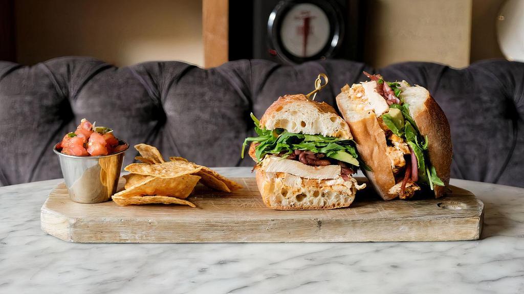 Roasted Chicken Sandwich · Roasted chicken, chili mayonnaise, pickled onions, arugula, sliced avocado on a French baguette