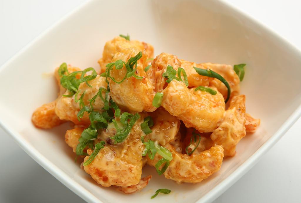 Rock Shrimp · Tempura battered shrimp that is fried and tossed in a spicy mayo, then garnished with scallions and fish roe.