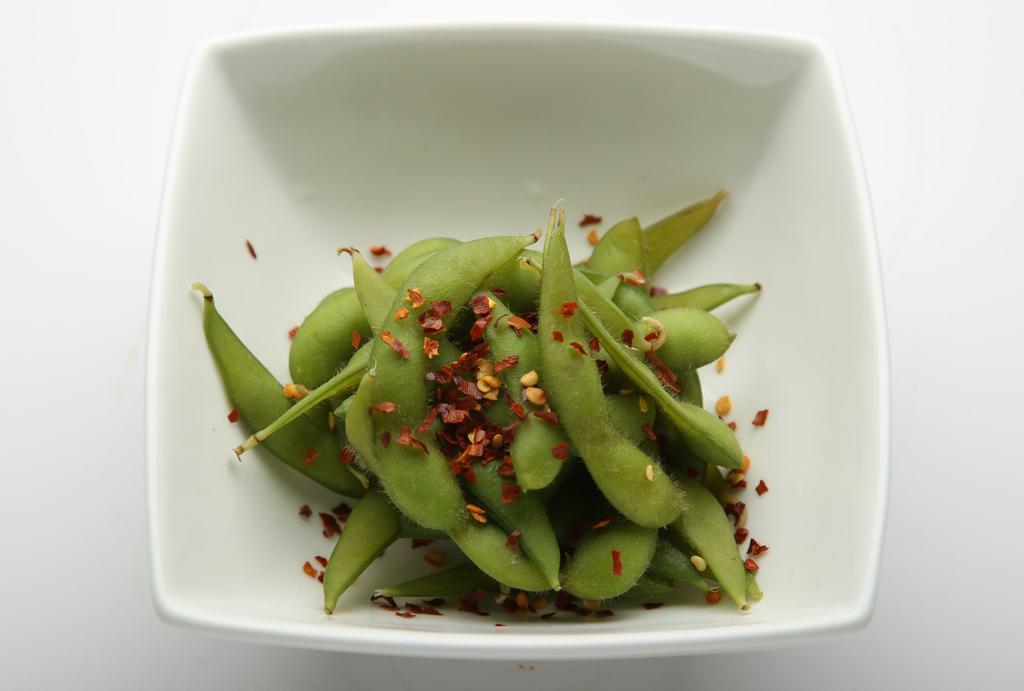 Edamame · Steamed edamame, tossed in a citrus and sesame vinaigrette