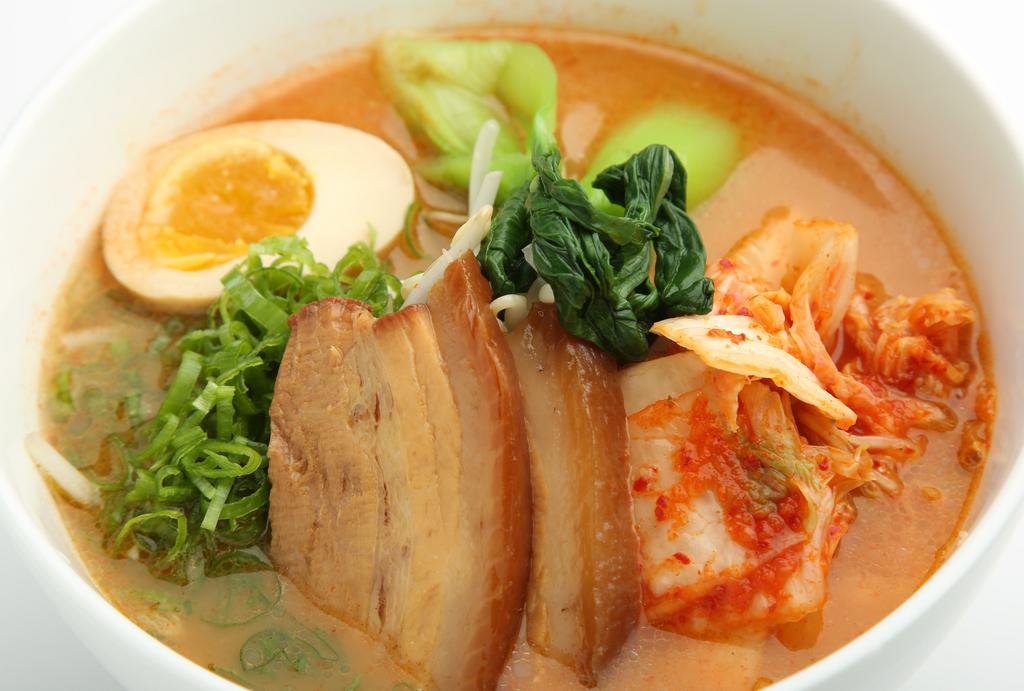 Kimchi Ramen · Kimchi ramen with a pork soup base. Topped with sliced pork belly, kimchi, bean sprouts, bamboo shoots, bok choy, fish cake, egg and scallions.