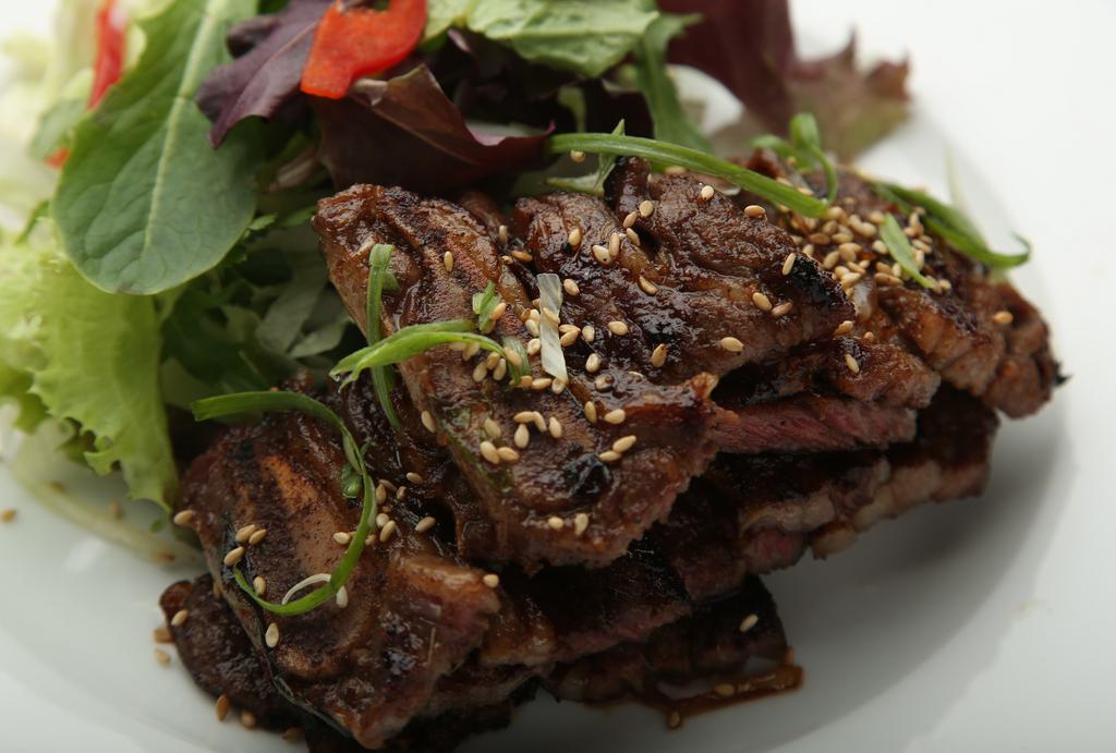 Kalbi · Korean-style grilled short ribs, served with rice and salad.