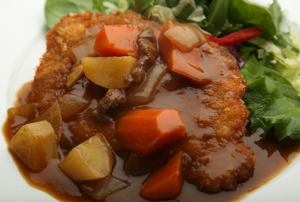 Pork Katzu Curry · Fried pork served with curry on top. Platter comes with rice and salad.