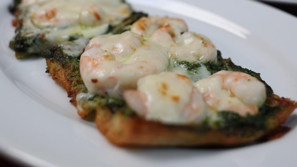 Shrimp Pesto Flatbread · Crispy flatbread topped with pesto sauce, garlic chili oil, shrimp and mozzarella cheese