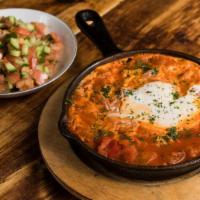 Shakshuka · Two eggs poached in a spicy Moroccan tomato sauce, cooked, and served in a skillet.