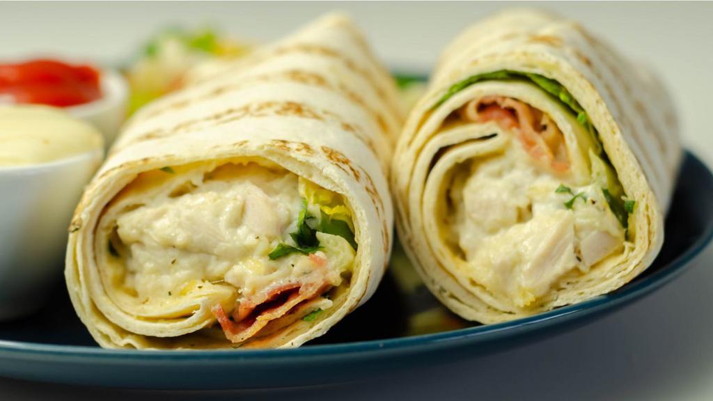 Buffalo Chicken Wrap · Fresh Wrap made with Grilled Buffalo chicken, bacon, Swiss, lettuce, tomatoes and blue cheese dressing.
