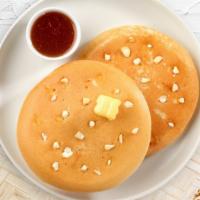Snowy Chocolate Pancakes · Fluffy white chocolate chip pancakes cooked with care and love served with butter and maple ...