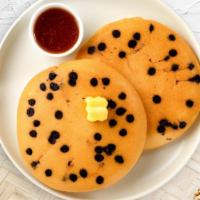 Chocolatey Buddy Pancakes · Fluffy chocolate chip pancakes cooked with care and love served with butter and maple syrup....