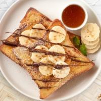Choco Nuts And Bananas French Toast · Fresh bread battered in egg, milk, and cinnamon cooked until spongy and golden brown. Topped...