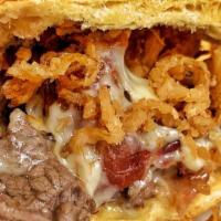 Filet Mignon Sandwich · Crispy onion, bacon, provolone, and truffle butter. Served with French fries.
