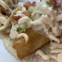 Baja Fish Taco · Crispy homemade battered fish, on our handmade blue corn tortilla with onions, cilantro, cuc...