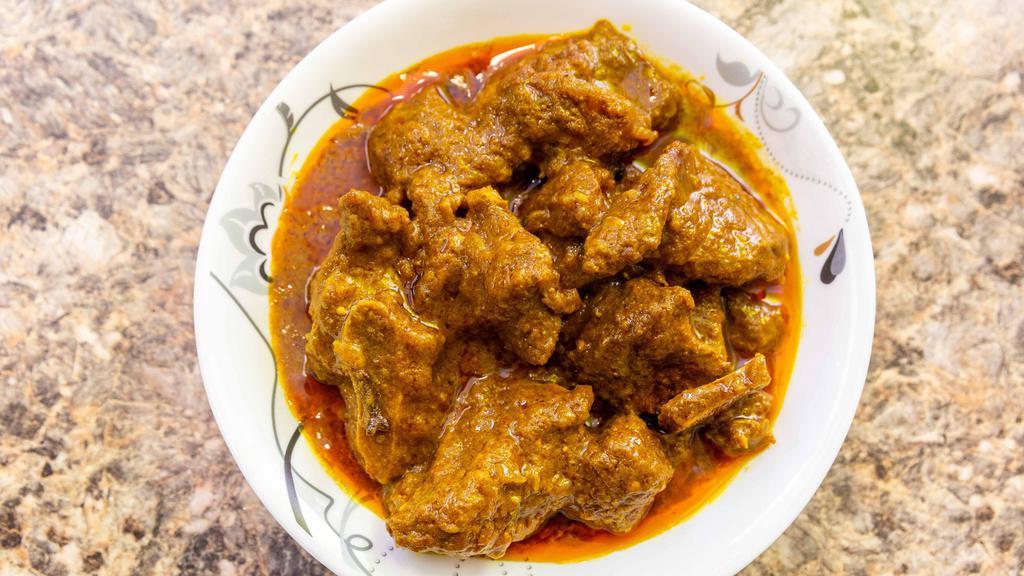 Curry Goat · Goat cooked with spices, gravy.