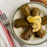 Dolmadakia · Homemade grape leaves served warm and stuffed with rice, fresh dill, lemon and Greek olive o...