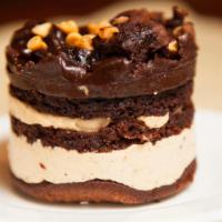 Peanut Butter Explosion · Brownie bottom, layers of velvety peanut mousse, chocolate genoise, topped with peanut butte...