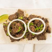 Mutton Barrah · Lamb marinated with 12 special spices and grilled on a pan.