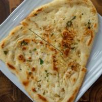 Garlic Naan · Freshly made refined flour bread with fresh garlic baked in clay oven.