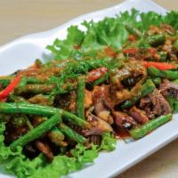 Ribeye With Pad Prik Khing · Grilled ribeye steak cooked to your preference, topped with sautéed string beans with spicy ...