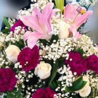 Big Rose Basket Arrangement  · Dozen of white roses, dozen of purple carnations, 1 pink lilie, in a wooden basket.