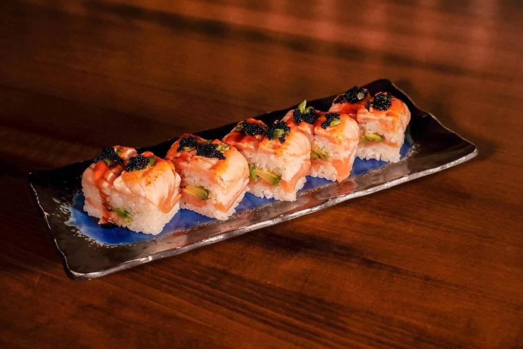Salmon Mille-Feuille Roll · Layered spicy salmon, seared salmon, avocado, jalapeno and sushi rice. Topped with tobiko and eel sauce and spicy mayo.