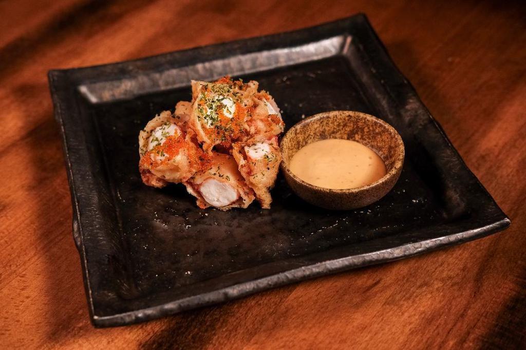 Popcorn Lobster · Coarsely chopped lobster tempura served with homemade spicy mayo. Topped with tobiko and seaweed flakes