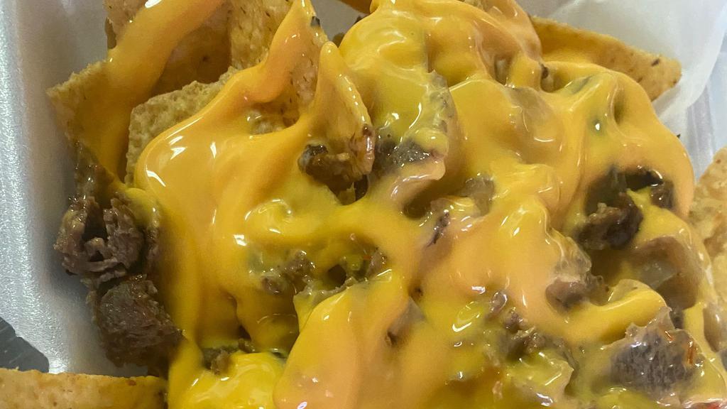 Loaded Nachos · Made to Order: nachos, nacho cheese, onions, peppers, sour cream , flava wingz special sauce, & your choice of chicken or steak.